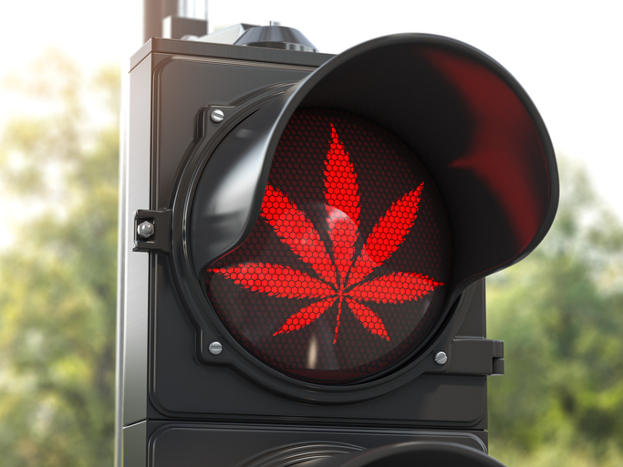 Cannabis leaf on red traffic light. Cannabis and marijuana prohibition concept for BLAZE.me blog